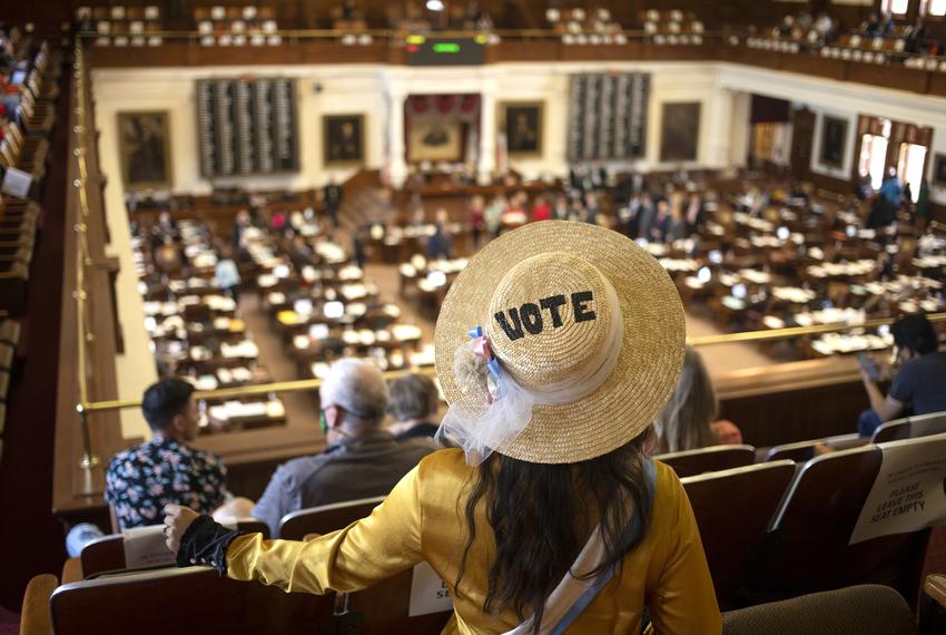 A visitor of the House gallery listens to legislators speak during a debate on an abortion bill being considered on the House floor on May 5, 2021.